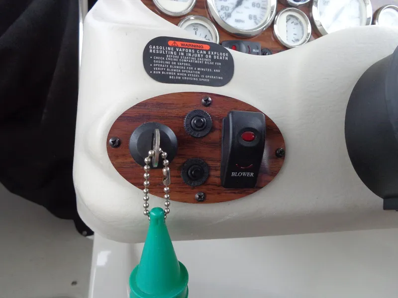 Slide: The Image of Dashboard of a 2009 Glastron GT 185 boat with ignition and blower switch. - 42