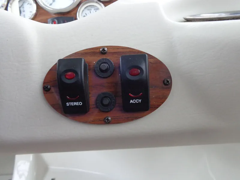 Slide: The Image of Dashboard switches on a 2009 Glastron GT 185 boat, featuring stereo and accessory controls. - 43