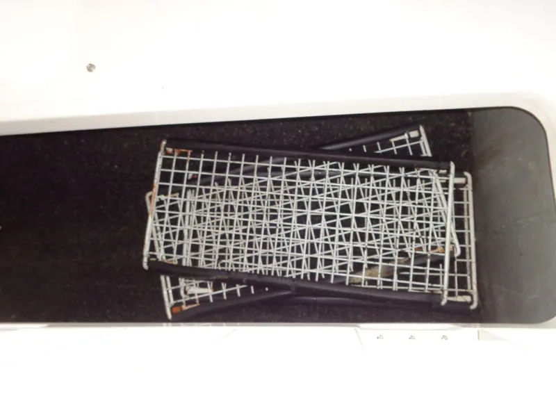 Slide: The Image of Storage compartment of 2009 Glastron GT 185 boat with metal racks inside. - 47