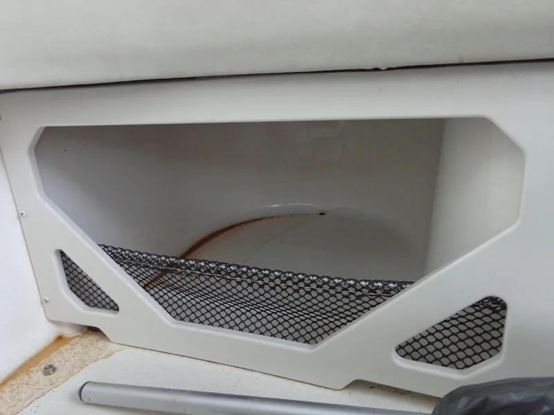 Slide: The Image of Storage compartment in 2009 Glastron GT 185 boat with mesh netting. - 49