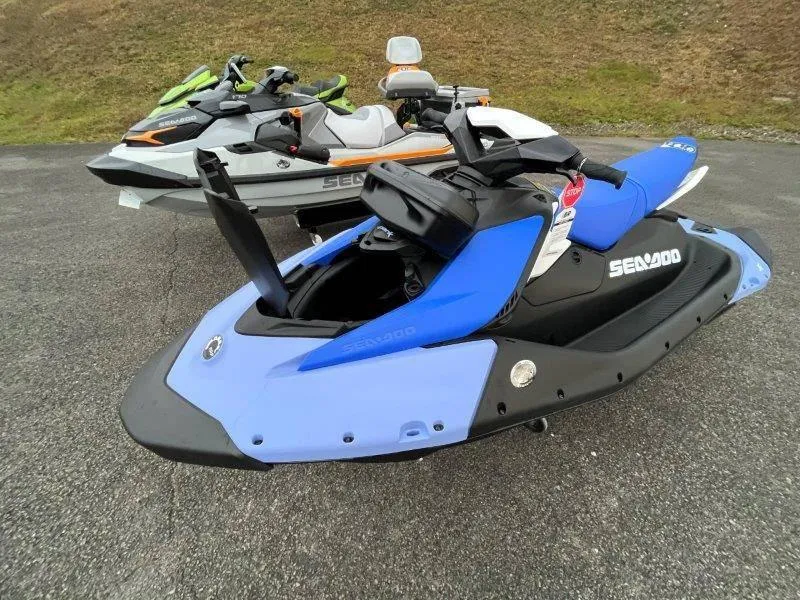 Slide: The Image of 2024 Sea-Doo Spark jet skis parked on asphalt, featuring vibrant colors and sleek design. - 14