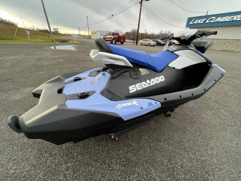 Slide: The Image of 2024 Sea-Doo Spark jet ski with iBR and audio, parked outdoors. - 24