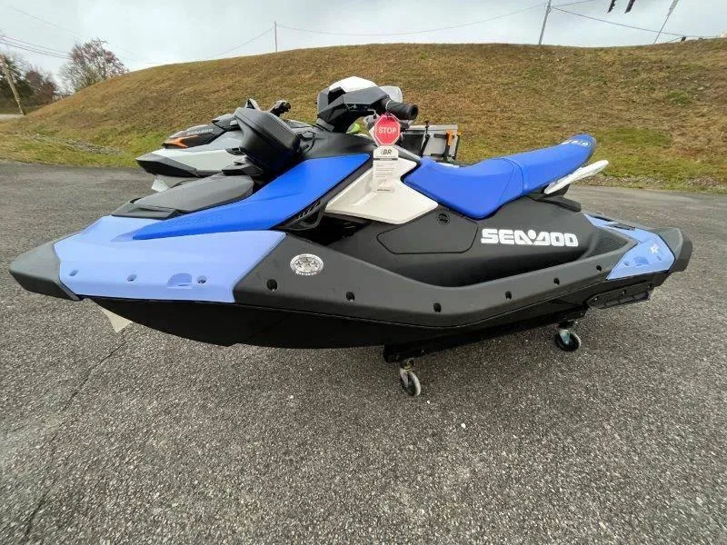 Slide: The Image of 2024 Sea-Doo Spark jet ski with iBR and audio, parked on pavement. - 32