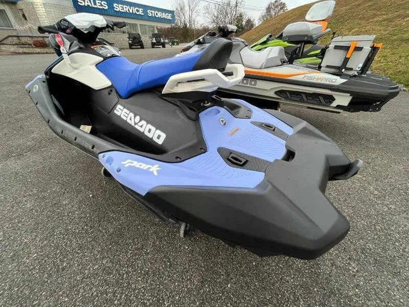 Slide: The Image of 2024 Sea-Doo Spark jet ski with iBR and audio, parked outdoors. - 33