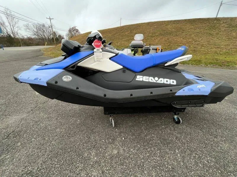 Slide: The Image of 2024 Sea-Doo Spark jet ski with iBR and audio, parked on pavement. - 6