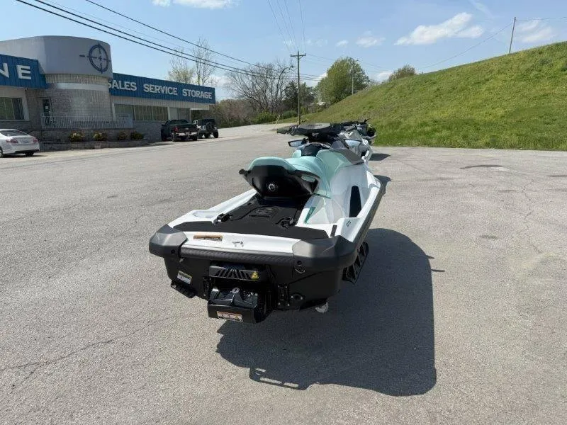 Slide: The Image of 2024 Sea-Doo GTI 130 jet ski parked outdoors near a service center. - 13