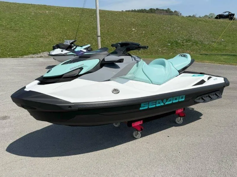 Slide: The Image of 2024 Sea-Doo GTI 130 jet ski in mint green and white on display outdoors. - 22