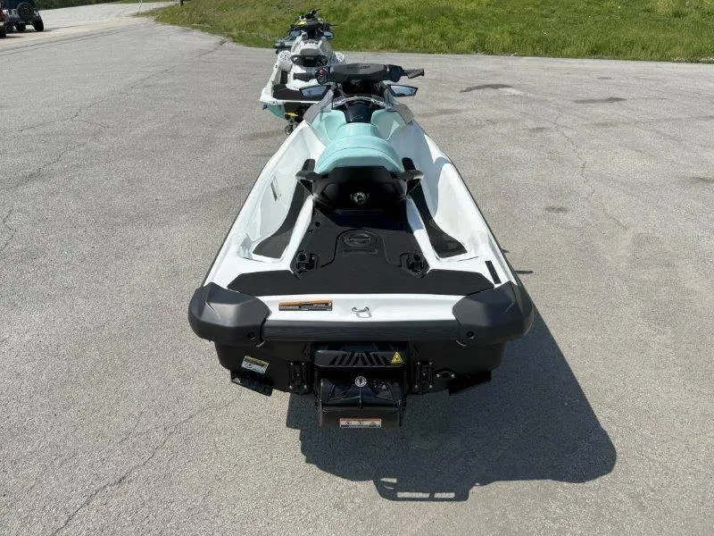 Slide: The Image of 2024 Sea-Doo GTI 130 jet ski parked on pavement, rear view. - 23