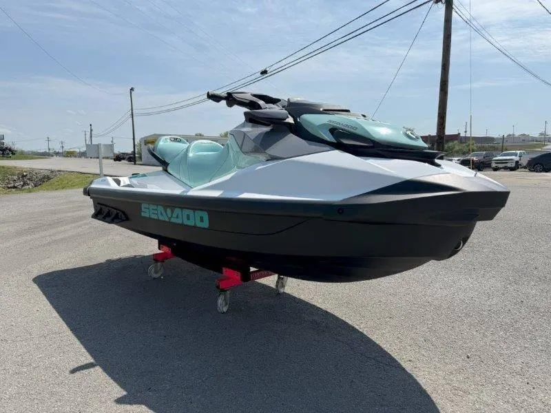 Slide: The Image of 2024 Sea-Doo GTI 130 jet ski on pavement under clear sky. - 3