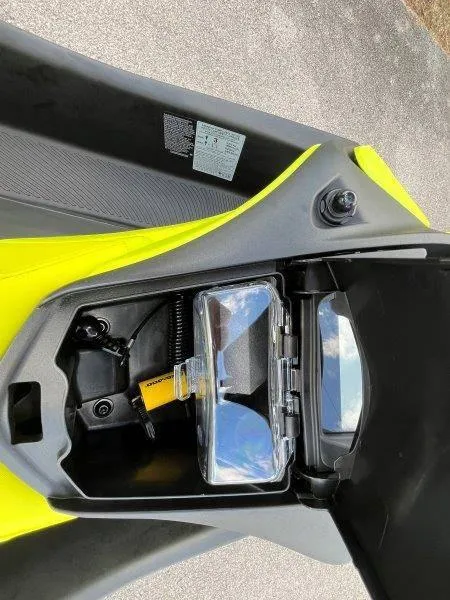 Slide: The Image of 2024 Sea-Doo Spark Trixx storage compartment with sunglasses and accessories. - 10