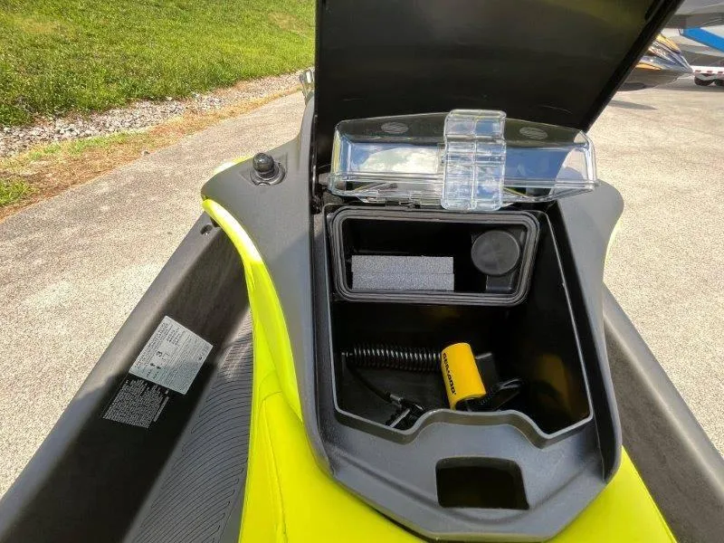 Slide: The Image of 2024 Sea-Doo Spark Trixx storage compartment open, showcasing interior features and accessories. - 11