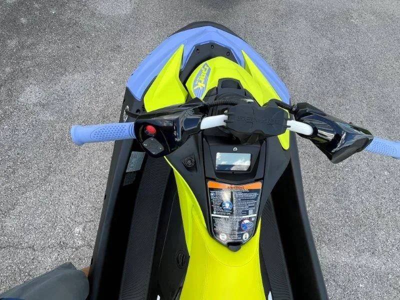 Slide: The Image of 2024 Sea-Doo Spark Trixx jet ski, vibrant yellow and blue design, top view. - 12