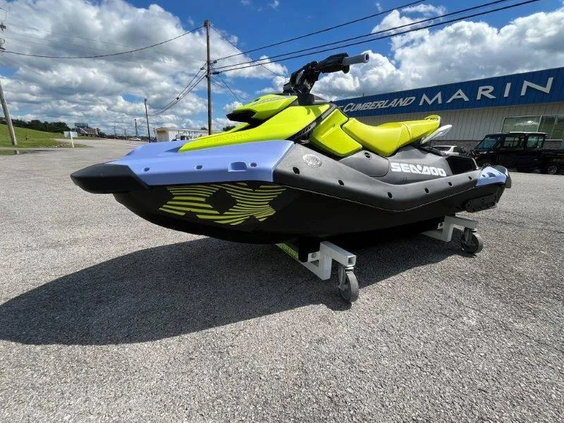 Slide: The Image of 2024 Sea-Doo Spark Trixx jet ski in vibrant colors, parked outdoors. - 19
