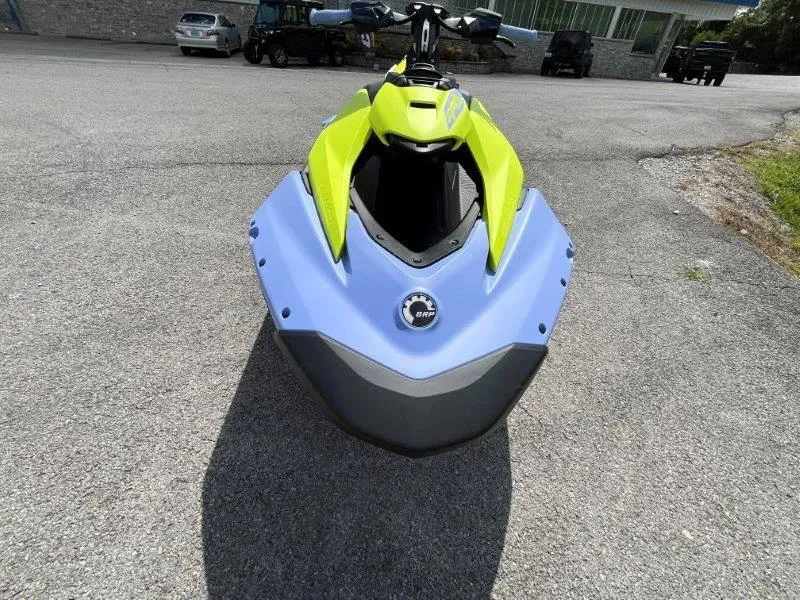 Slide: The Image of 2024 Sea-Doo Spark Trixx jet ski, vibrant yellow and blue, front view. - 20