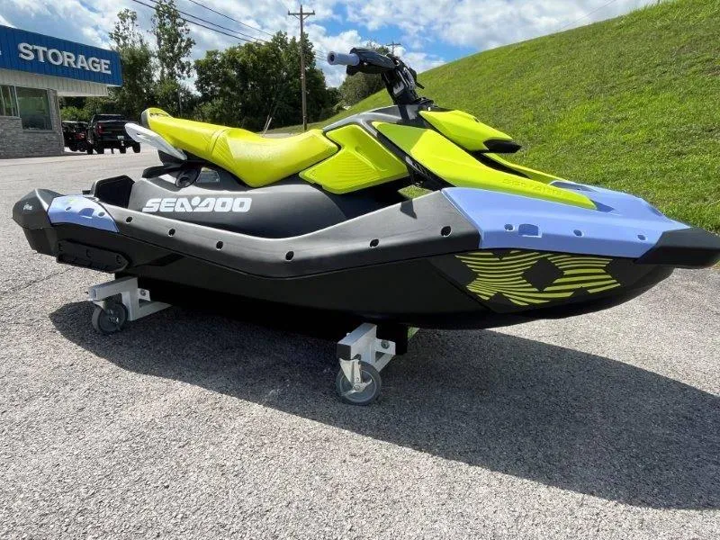 Slide: The Image of 2024 Sea-Doo Spark Trixx jet ski with vibrant yellow and black design on pavement. - 27
