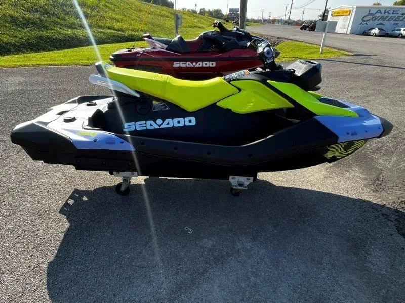 Slide: The Image of 2024 Sea-Doo Spark Trixx jet ski in vibrant yellow and black, parked outdoors. - 10