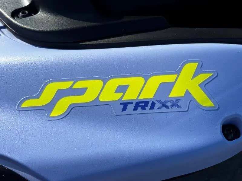 Slide: The Image of 2024 Sea-Doo Spark Trixx logo on blue watercraft body. - 11