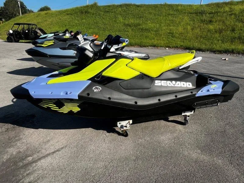 Slide: The Image of 2024 Sea-Doo Spark Trixx jet ski with vibrant yellow and black design on pavement. - 3