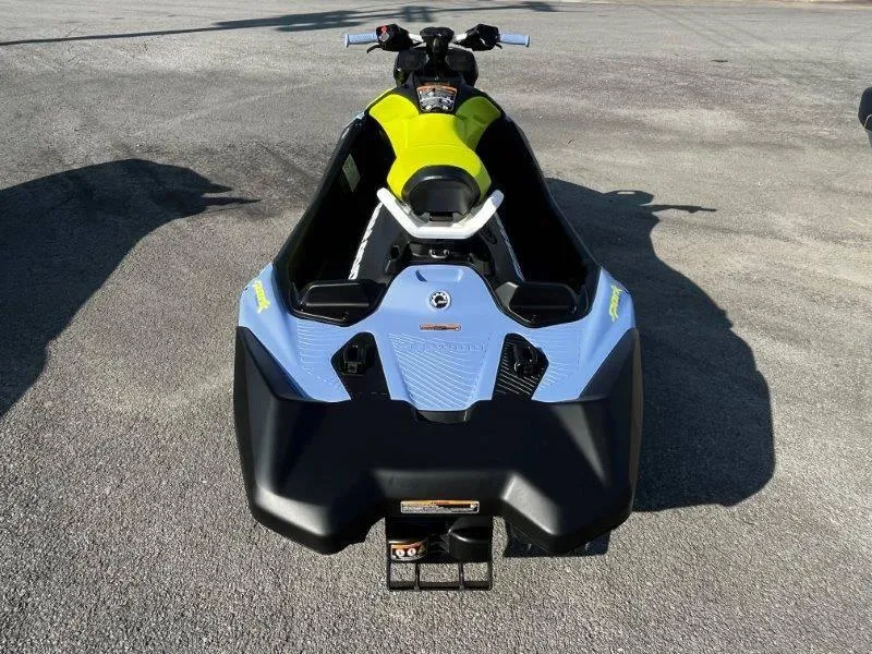 Slide: The Image of 2024 Sea-Doo Spark Trixx jet ski, vibrant design, parked on pavement. - 31