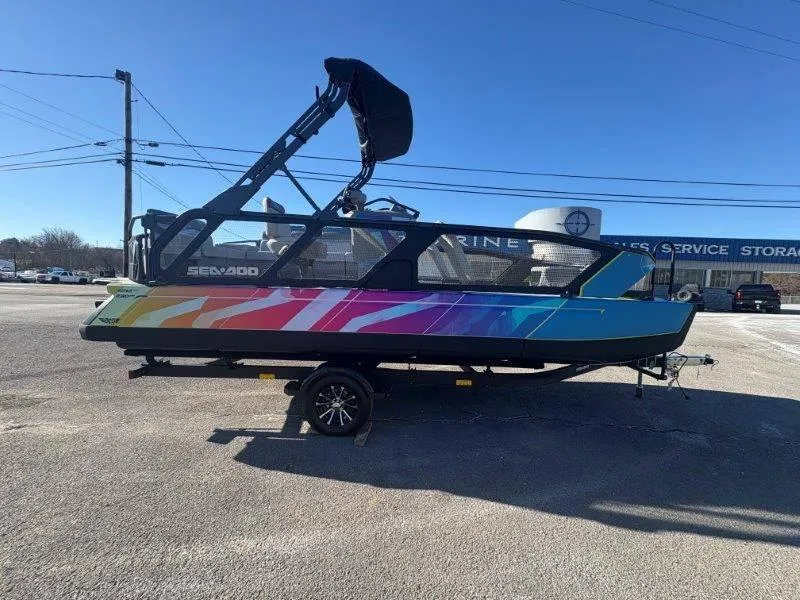 Slide: The Image of 2023 Sea-Doo SWITCH SPORT 21' 230HP boat with colorful design on trailer. - 17
