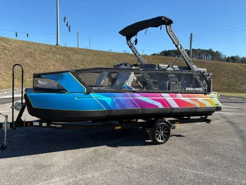 Slide: The Image of 2023 Sea-Doo SWITCH SPORT 21' 230HP boat with vibrant rainbow design on trailer. - 18