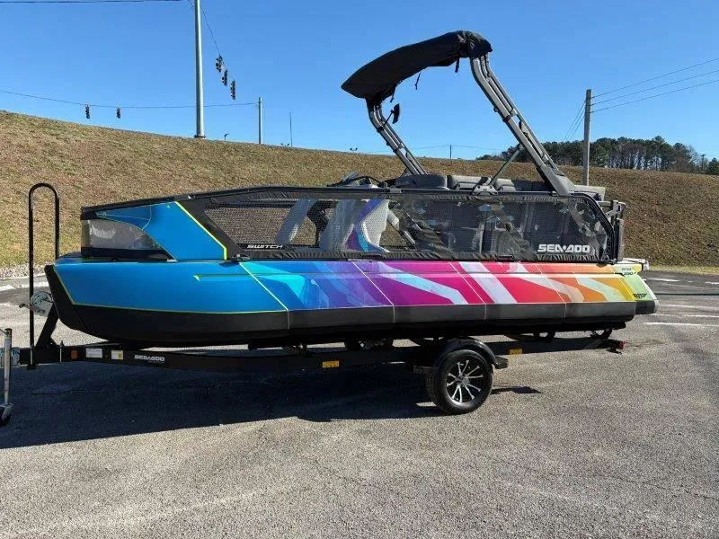 Slide: The Image of 2023 Sea-Doo SWITCH SPORT 21' 230HP with vibrant rainbow design on trailer. - 19