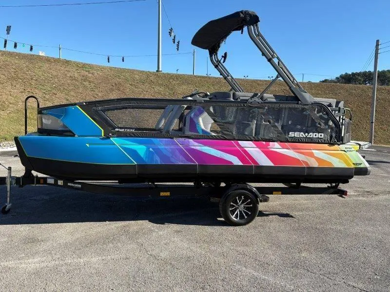 Slide: The Image of 2023 Sea-Doo SWITCH SPORT 21' 230HP boat with vibrant multicolor design on trailer. - 20
