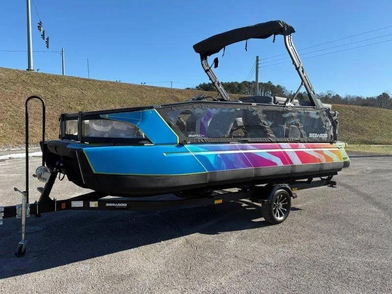Slide: The Image of 2023 Sea-Doo SWITCH SPORT 21' 230HP boat with colorful design on trailer. - 21