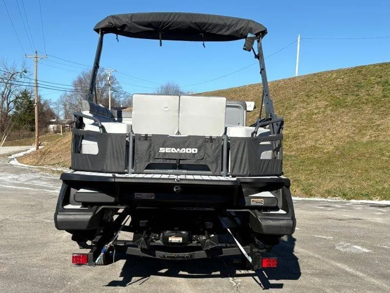 Slide: The Image of 2023 Sea-Doo SWITCH SPORT 21' 230HP boat, rear view, parked outdoors. - 6