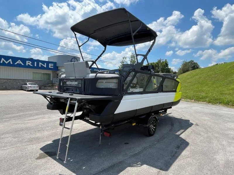 Slide: The Image of 2024 Sea-Doo Switch Cruise 21' 230HP boat with canopy in a parking lot. - 15