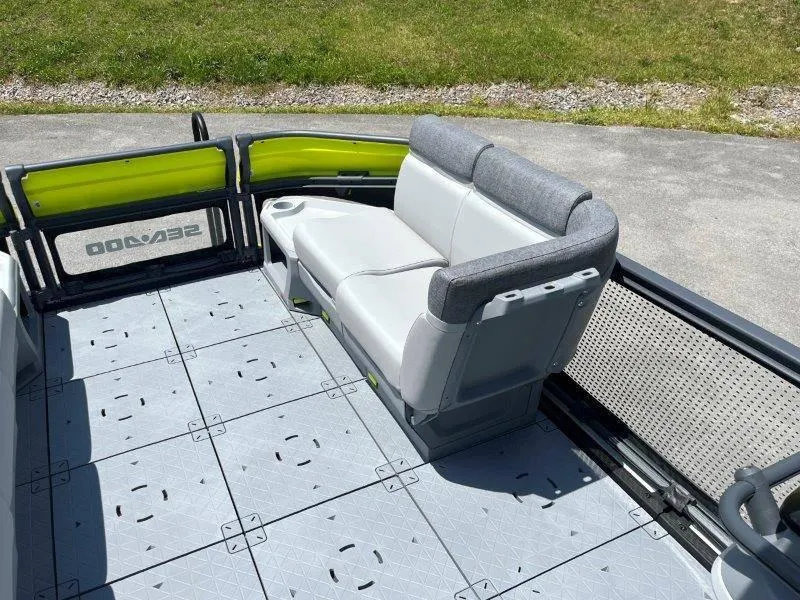 Slide: The Image of 2024 Sea-Doo Switch Cruise 21' 230HP boat interior with gray seating and modular flooring. - 24