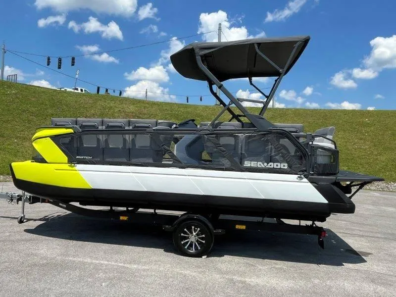 Slide: The Image of 2024 Sea-Doo Switch Cruise 21' 230HP pontoon boat on trailer, under blue sky. - 3
