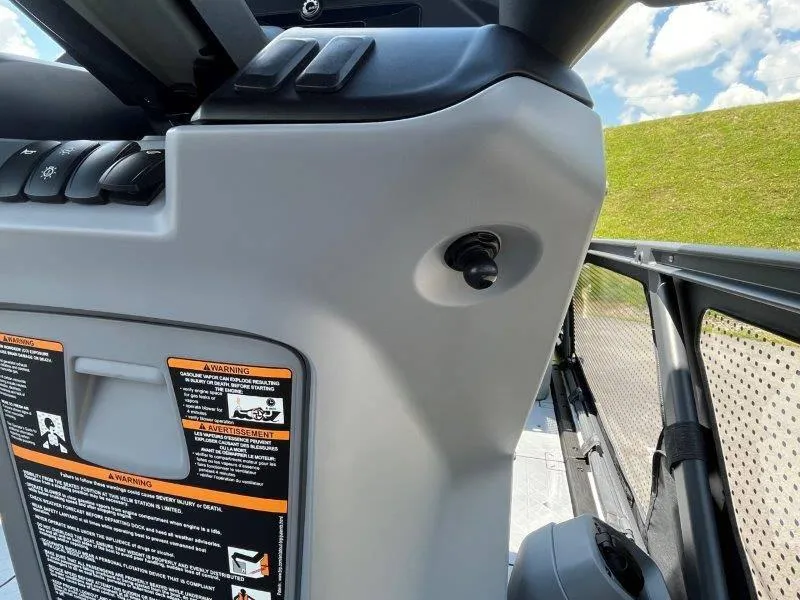 Slide: The Image of Close-up of 2024 Sea-Doo Switch Cruise 21' 230HP dashboard controls and warning labels. - 30