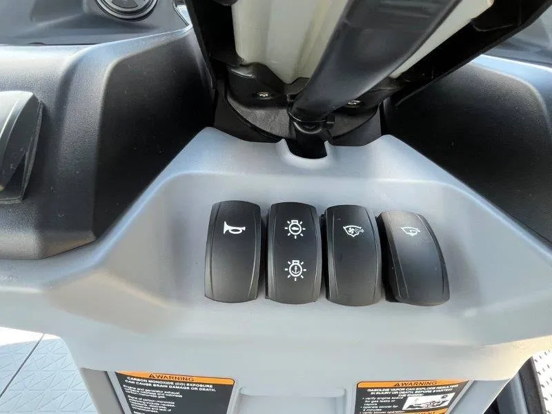 Slide: The Image of 2024 Sea-Doo Switch Cruise 21' 230HP dashboard controls with horn and light switches. - 32