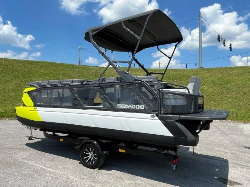 Slide: The Image of 2024 Sea-Doo Switch Cruise 21' 230HP boat with canopy on trailer, outdoors. - 4