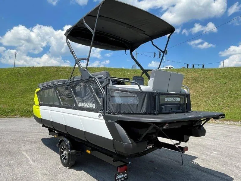 Slide: The Image of 2024 Sea-Doo Switch Cruise 21' 230HP boat with canopy on trailer, parked outdoors. - 5