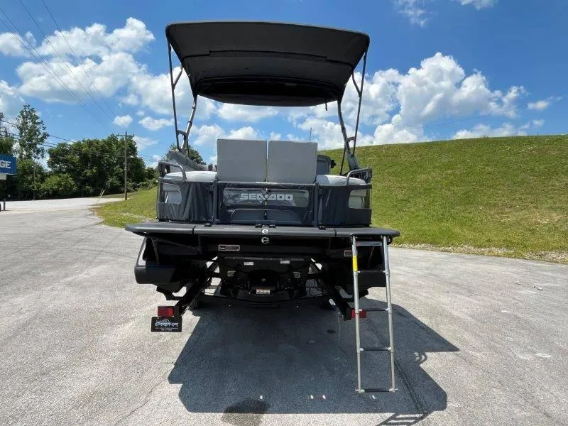Slide: The Image of 2024 Sea-Doo Switch Cruise 21' 230HP boat, rear view with ladder, parked outdoors. - 8