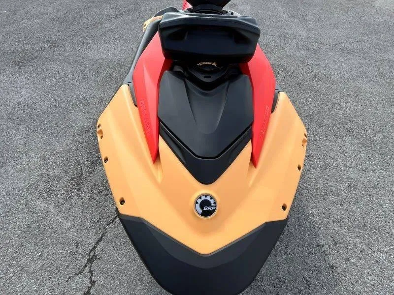 Slide: The Image of 2024 Sea-Doo Spark jet ski, orange and black, top view on pavement. - 11
