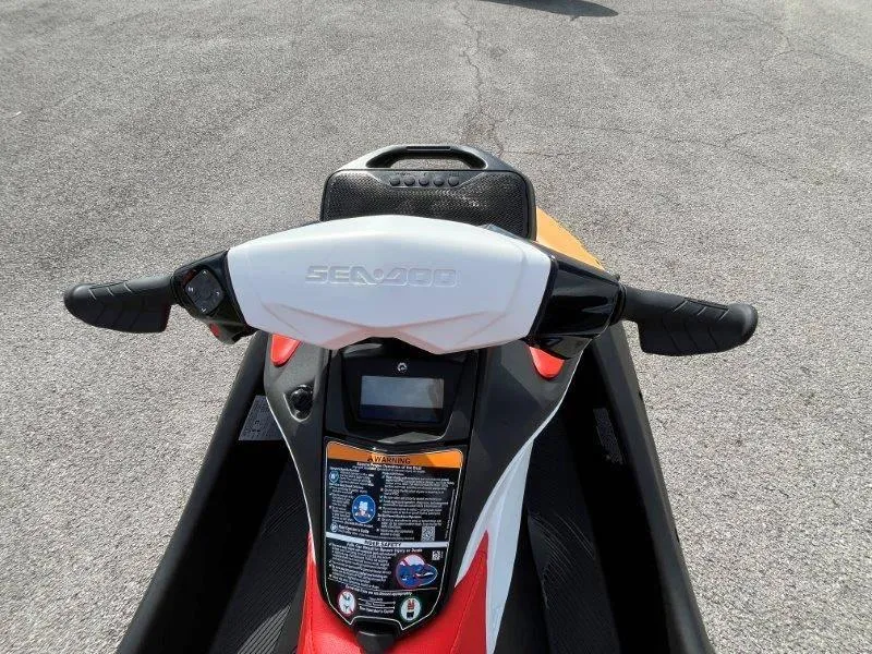 Slide: The Image of 2024 Sea-Doo Spark handlebars with iBR and audio system, on pavement. - 31