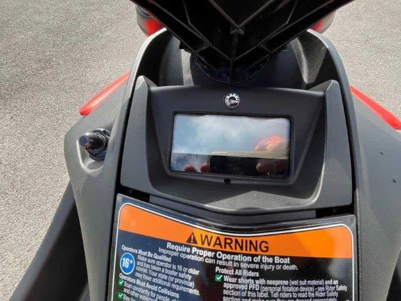 Slide: The Image of 2024 Sea-Doo Spark dashboard with warning label and display screen. - 33