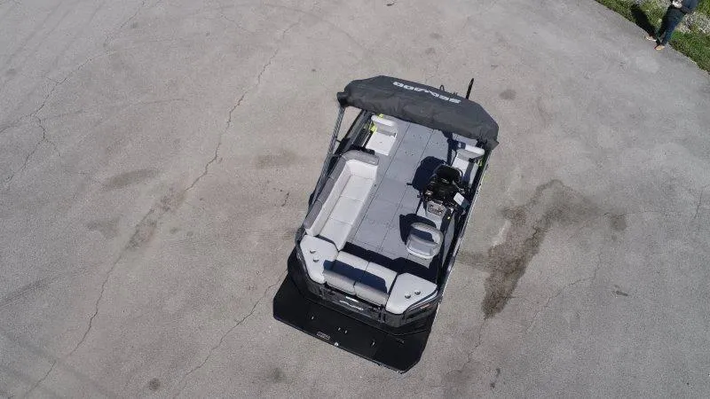Slide: The Image of 2024 Sea-Doo SWITCH SPORT 18' 230HP pontoon boat, aerial view, parked on pavement. - 13
