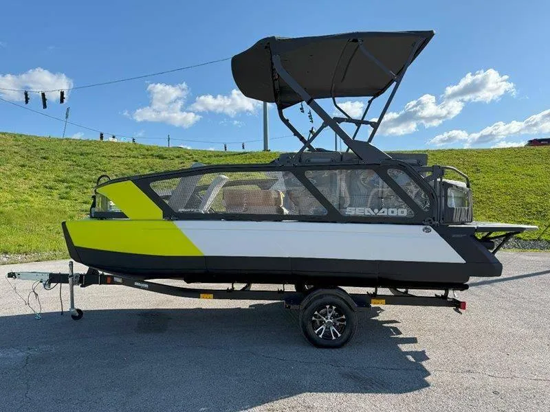 Slide: The Image of 2024 Sea-Doo SWITCH SPORT 18' 230HP boat on trailer, sunny day, green and white design. - 41