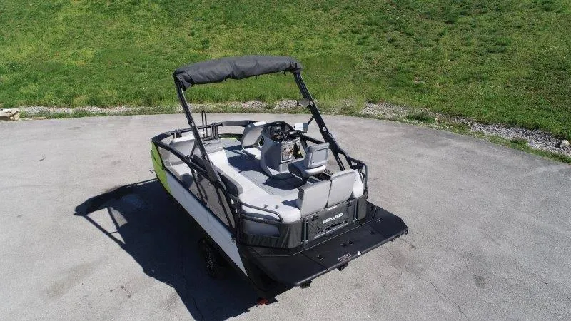 Slide: The Image of 2024 Sea-Doo SWITCH SPORT 18' 230HP boat on pavement, green grass background. - 6