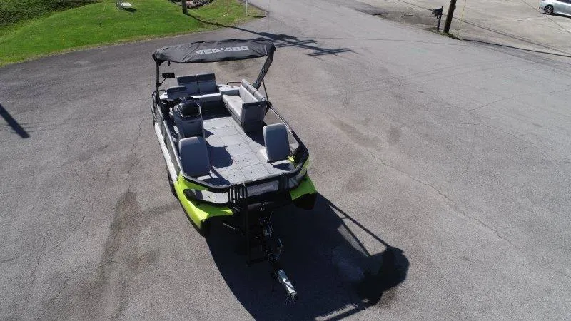 Slide: The Image of 2024 Sea-Doo SWITCH SPORT 18' 230HP boat on pavement, featuring a canopy and seating. - 8