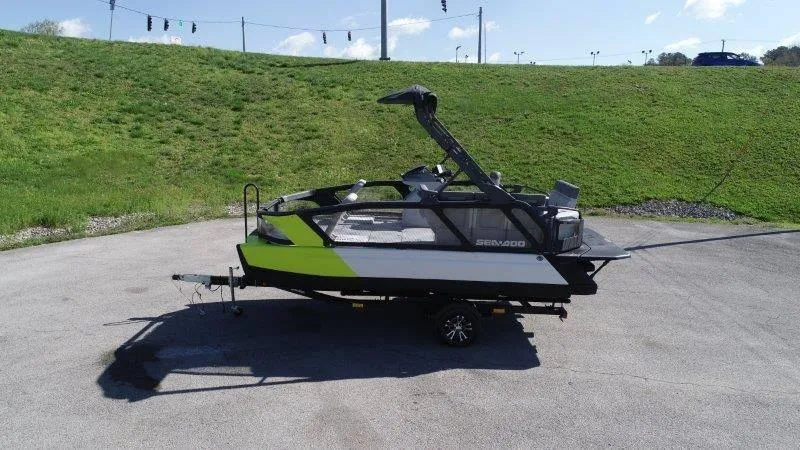 Slide: The Image of 2024 Sea-Doo SWITCH SPORT 18' 230HP boat on trailer, parked on asphalt. - 9
