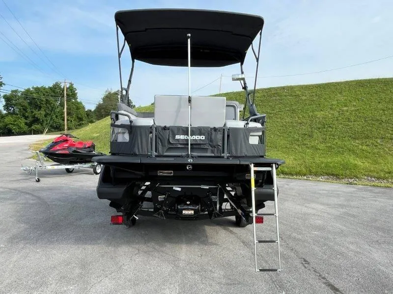 Slide: The Image of 2024 Sea-Doo SWITCH SPORT 18' 230HP boat with ladder and canopy, parked outdoors. - 13