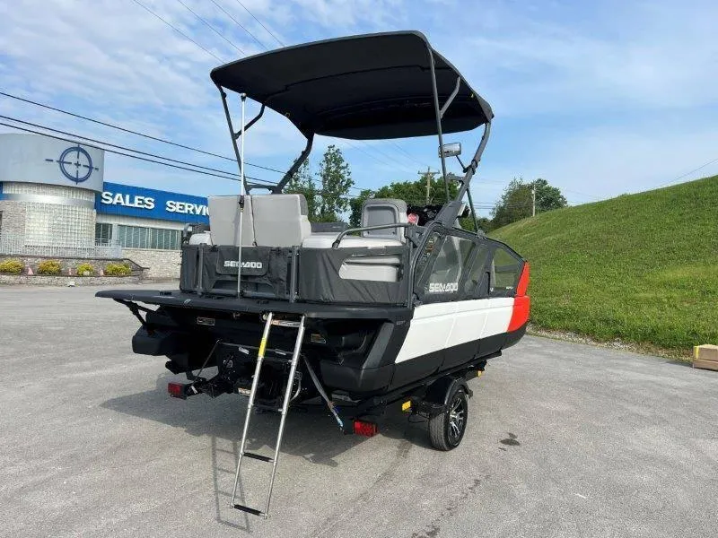 Slide: The Image of 2024 Sea-Doo SWITCH SPORT 18' 230HP boat with ladder, parked outdoors. - 17