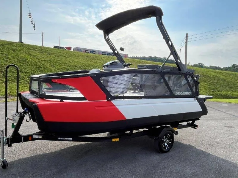 Slide: The Image of 2024 Sea-Doo SWITCH SPORT 18' 230HP on trailer, red and white design, parked outdoors. - 3