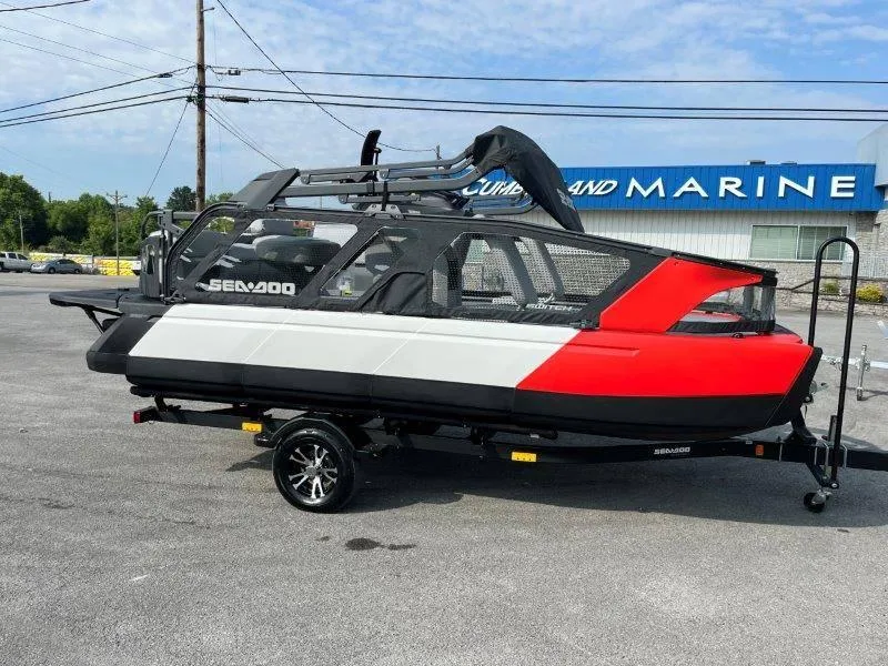 Slide: The Image of 2024 Sea-Doo SWITCH SPORT 18' 230HP boat on trailer, parked outside marine store. - 43