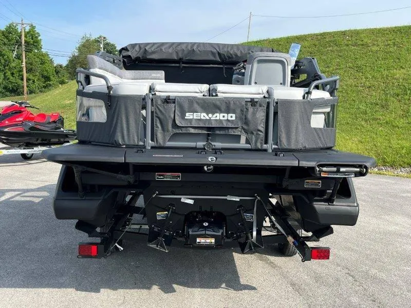 Slide: The Image of 2024 Sea-Doo SWITCH SPORT 18' 230HP rear view, parked on pavement. - 45